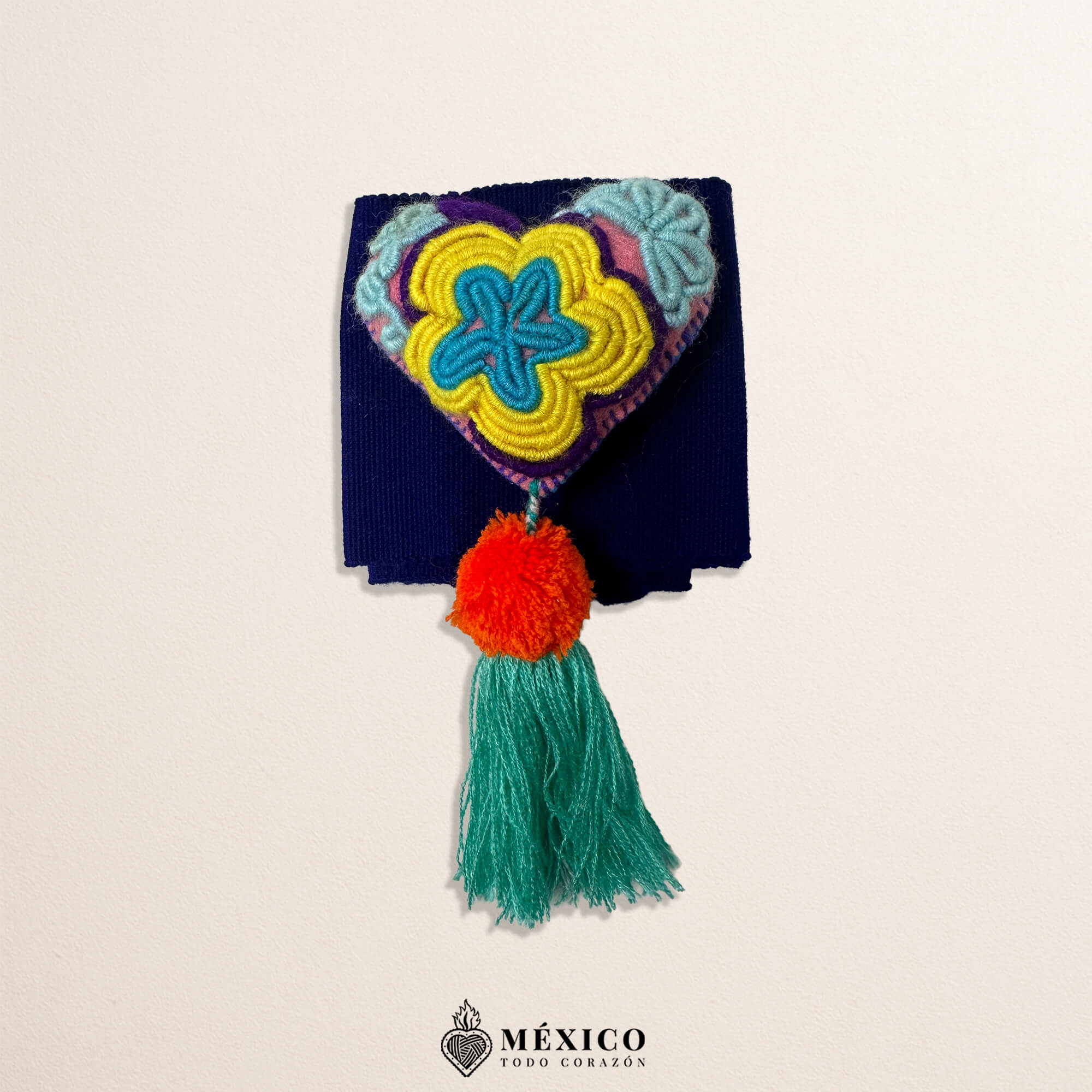 Purple Mexican waist belt featuring a heart embellishment made of multicolor yarn and pom-poms