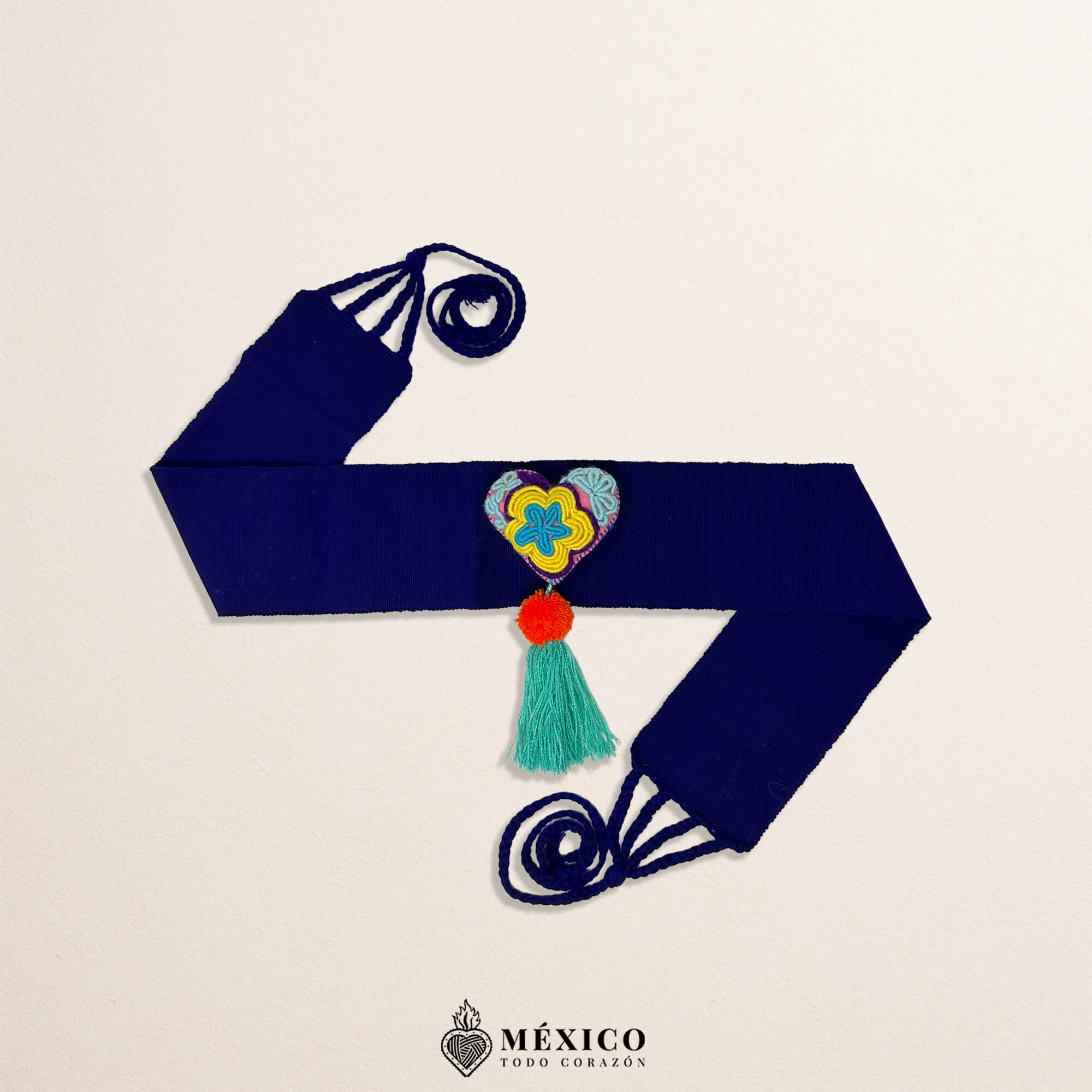 Purple Mexican waist belt featuring a heart embellishment made of multicolor yarn and pom-poms