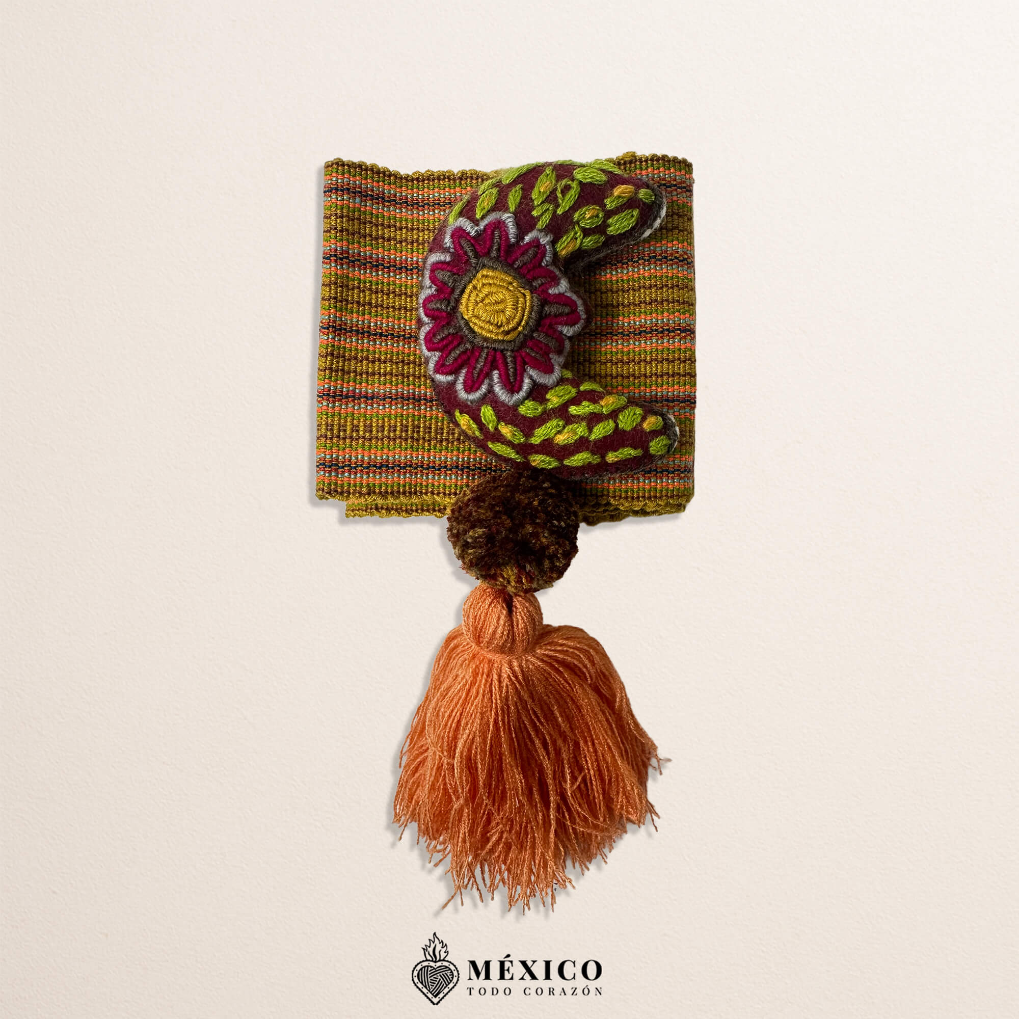 Brown artisan Mexican waist belt featuring a moon embellishment and pom-poms