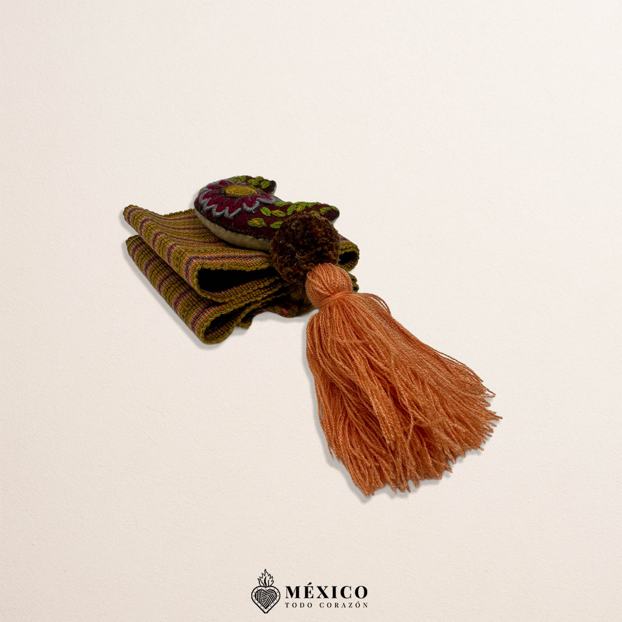 Brown artisan Mexican waist belt featuring a moon embellishment and pom-poms