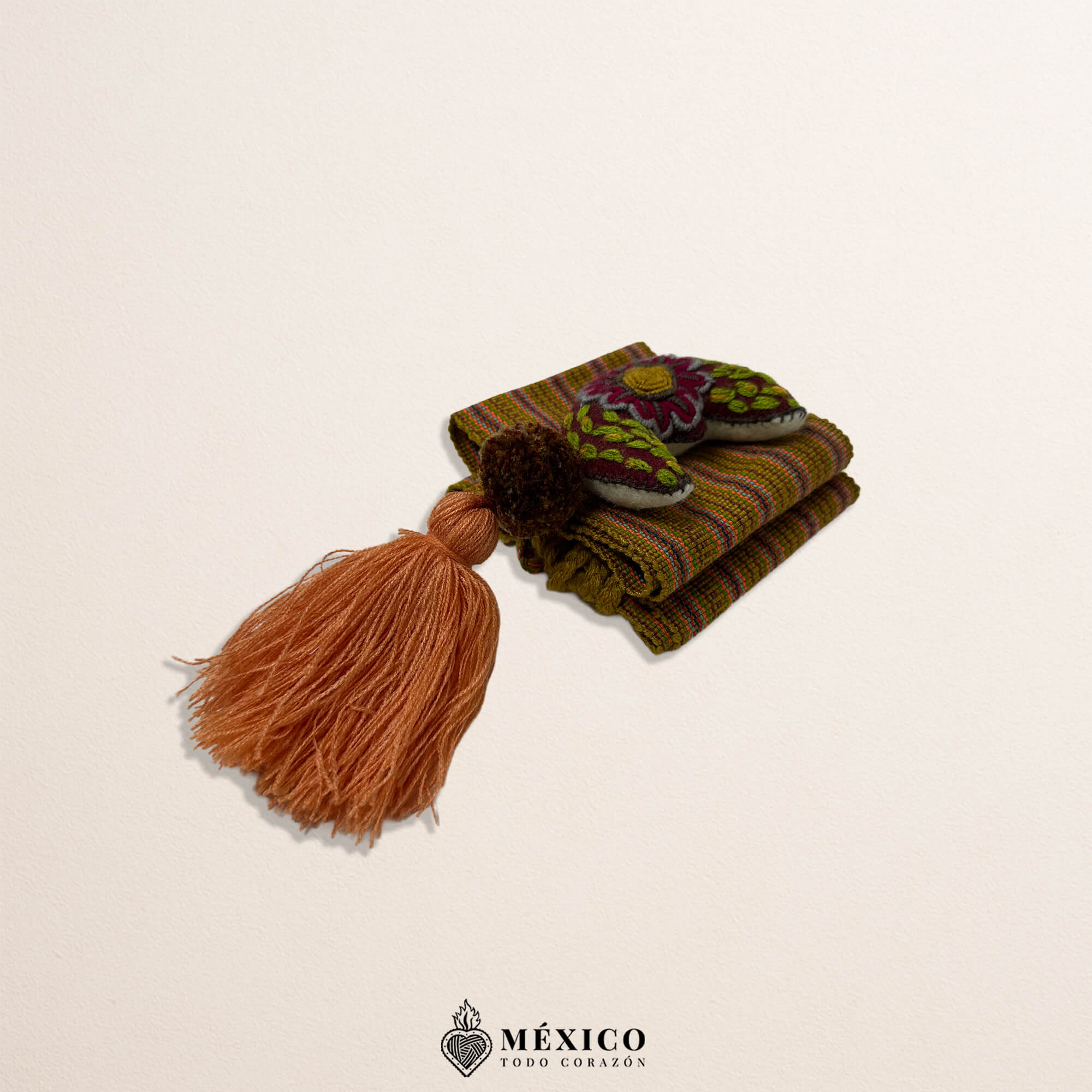 Brown artisan Mexican waist belt featuring a moon embellishment and pom-poms