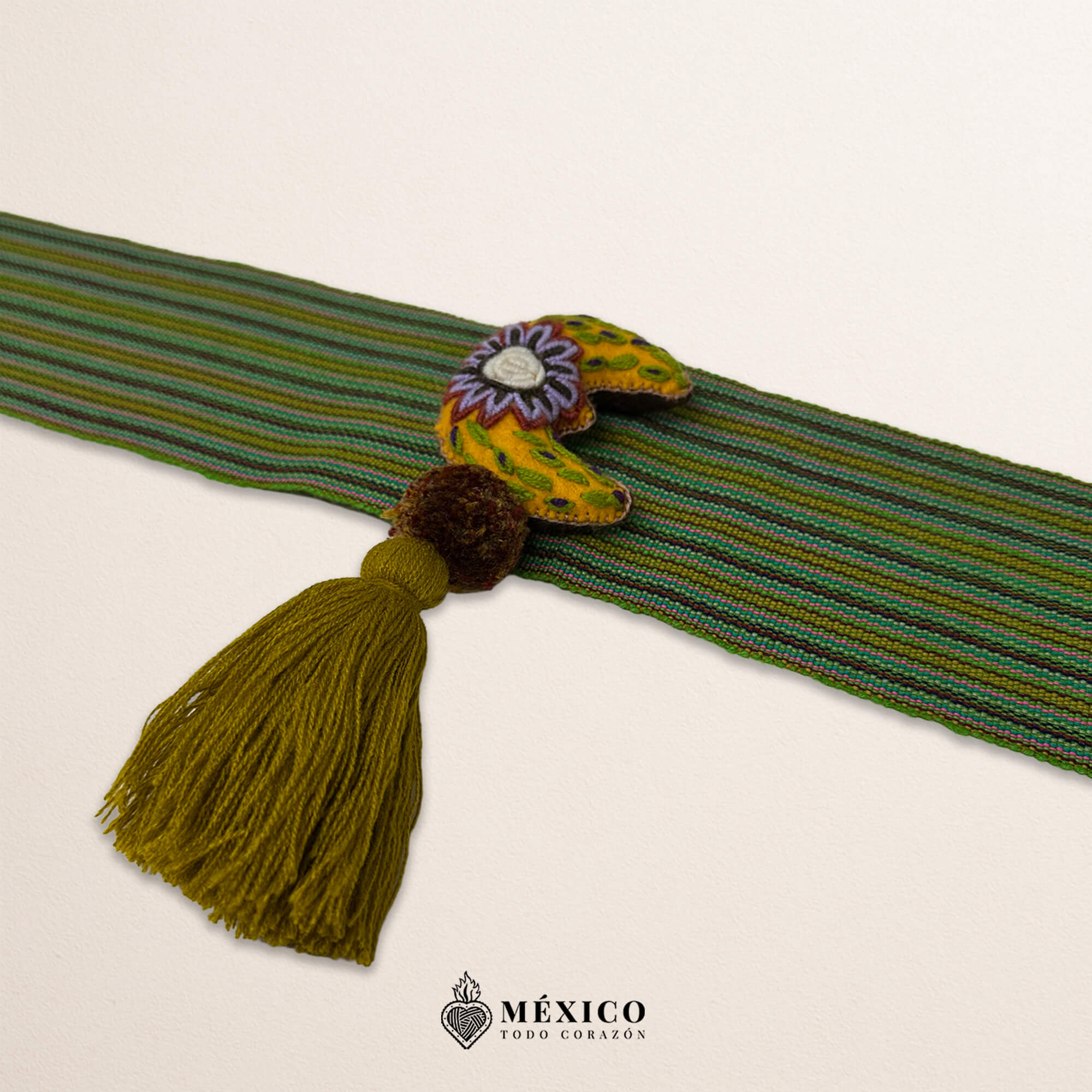 Green artisan Mexican waist belt featuring a floral moon embellishment in felt appliqué