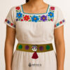 Beige artisan waist belt featuring a Mexican doll embellishment with multicolor pom-poms