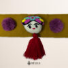 Beige artisan waist belt featuring a Mexican doll embellishment with multicolor pom-poms