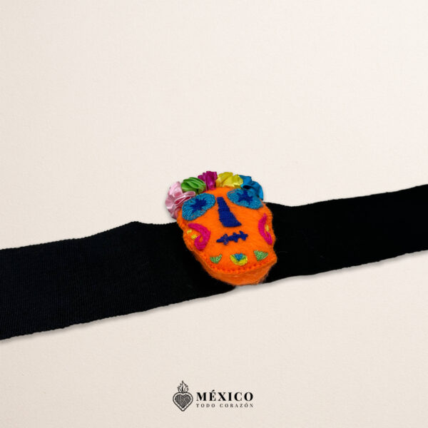 Black artisan Mexican waist belt featuring an orange Catrina embellishment in felt appliqué