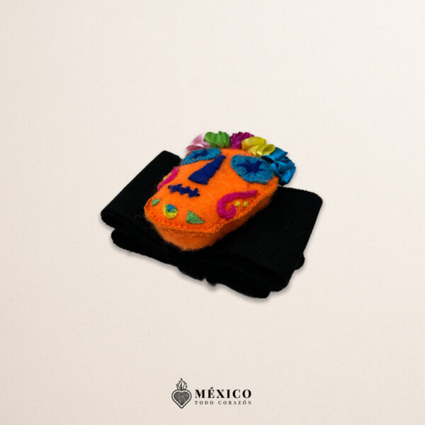 Black artisan Mexican waist belt featuring an orange Catrina embellishment in felt appliqué