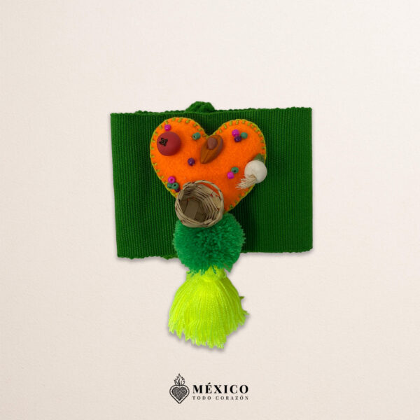 Green artisan Mexican waist belt featuring an orange heart embellishment in felt appliqué