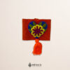 Orange artisan Mexican waist belt featuring a floral heart embellishment in felt appliqué
