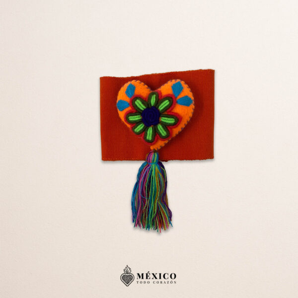 Orange artisan waist belt featuring a multicolor heart embellishment in felt appliqué