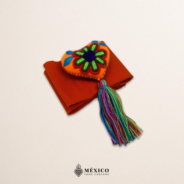 Orange artisan waist belt featuring a multicolor heart embellishment in felt appliqué