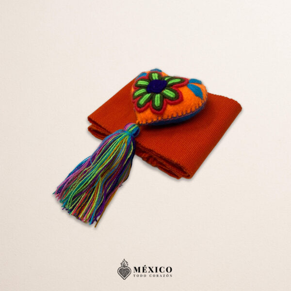 Orange artisan waist belt featuring a multicolor heart embellishment in felt appliqué