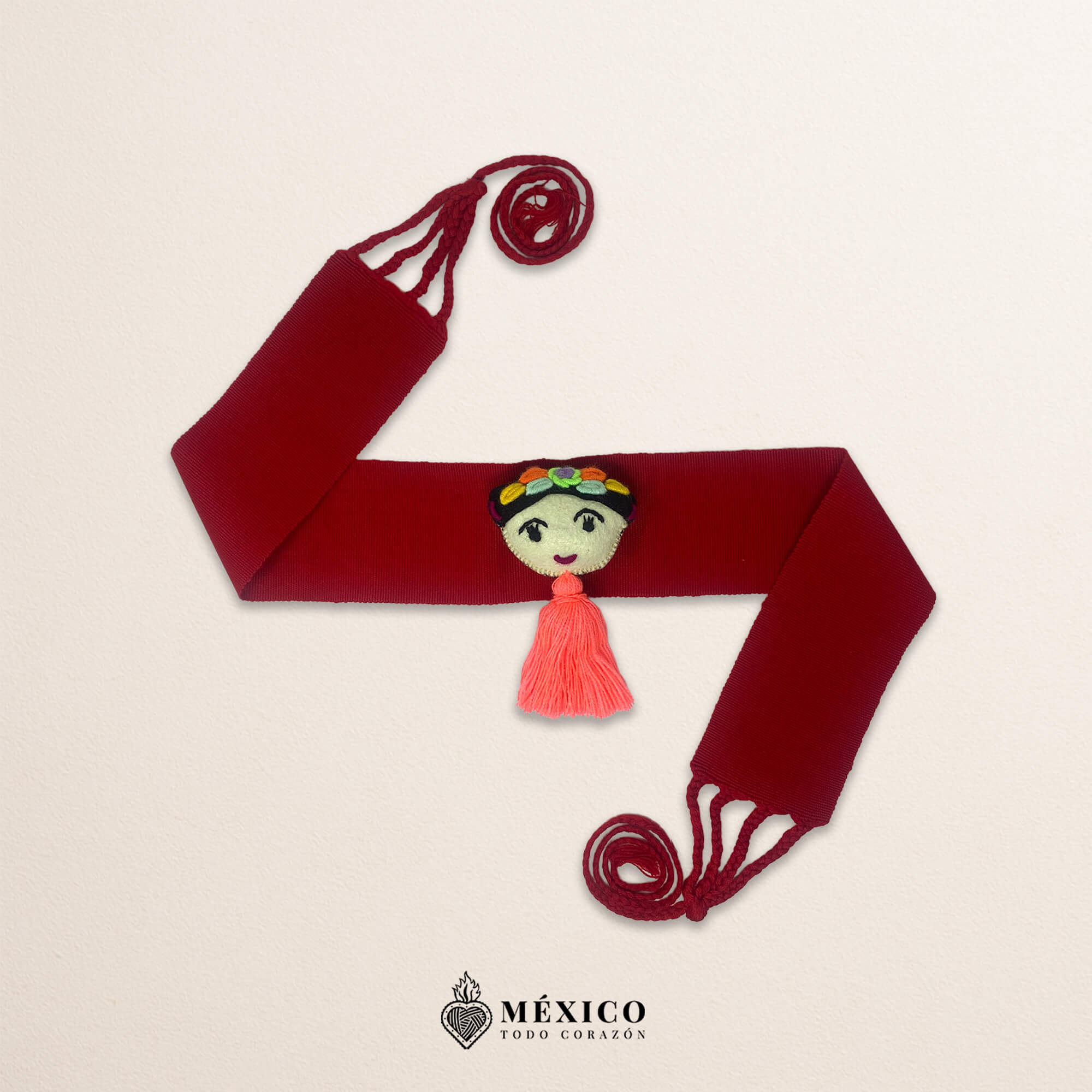 Red artisan Mexican waist belt featuring a Mexican doll embellishment in felt appliqué
