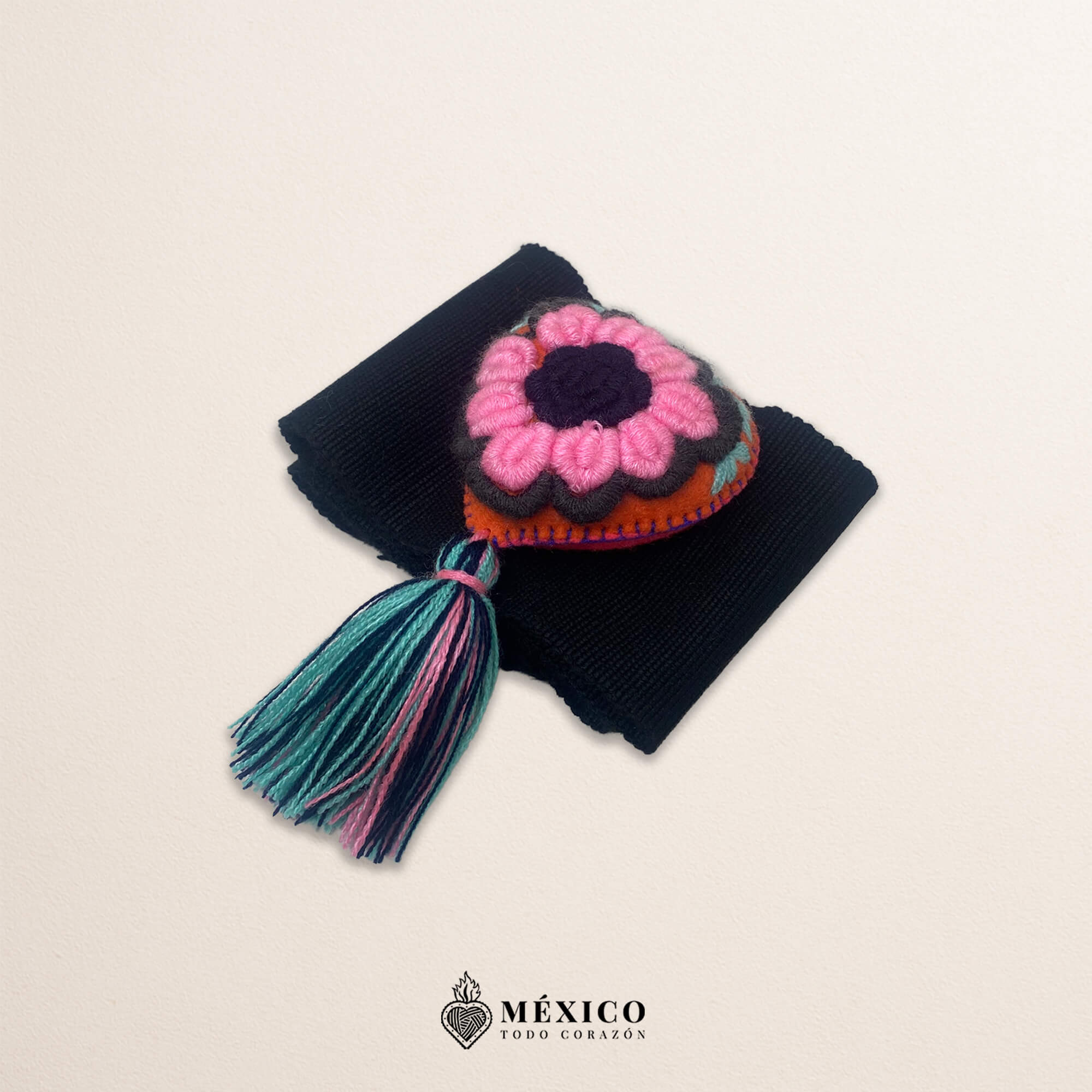 Black artisan Mexican waist belt featuring a floral heart embellishment in felt appliqué