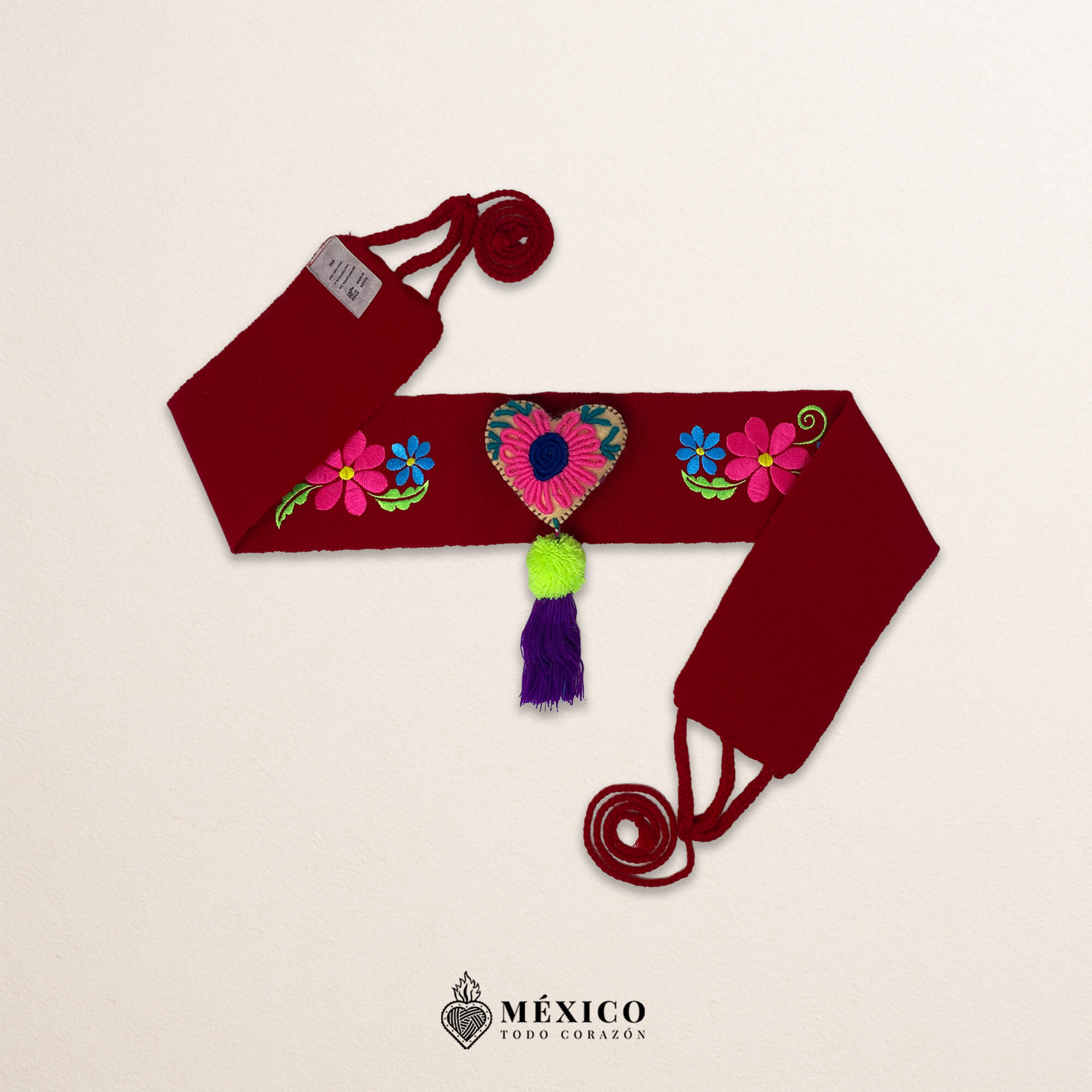 Red artisan waist belt featuring floral embroidery and a heart embellishment in multicolor felt