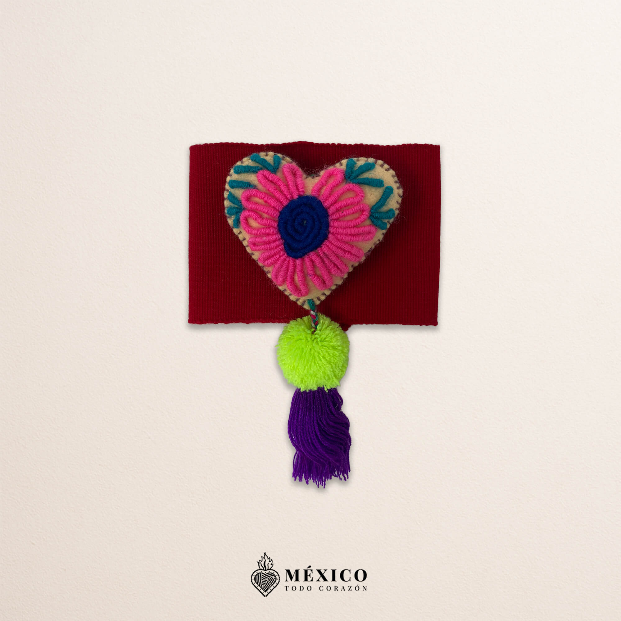 Red artisan waist belt featuring floral embroidery and a heart embellishment in multicolor felt