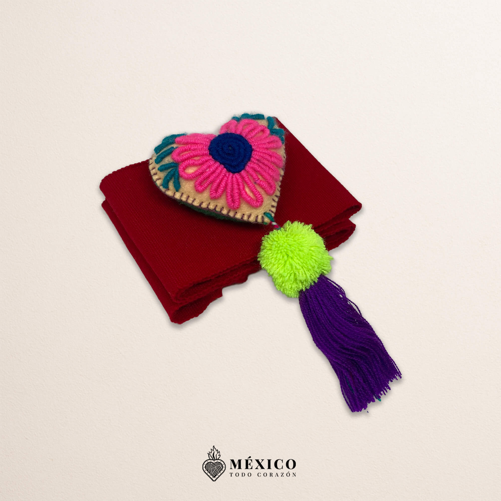 Red artisan waist belt featuring floral embroidery and a heart embellishment in multicolor felt