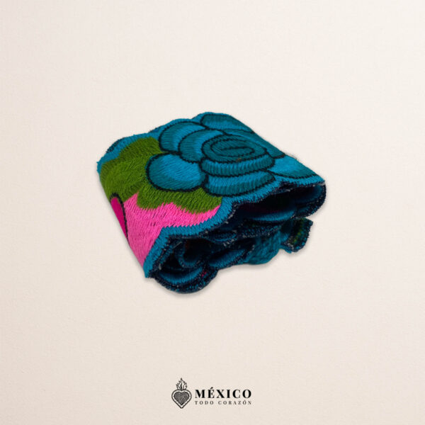 Handwoven small Mexican waist belt (faja) featuring colorful flower embellishments and blue ties