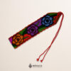 Handwoven Mexican waist belt (faja) featuring colorful flower embellishments and orange ties