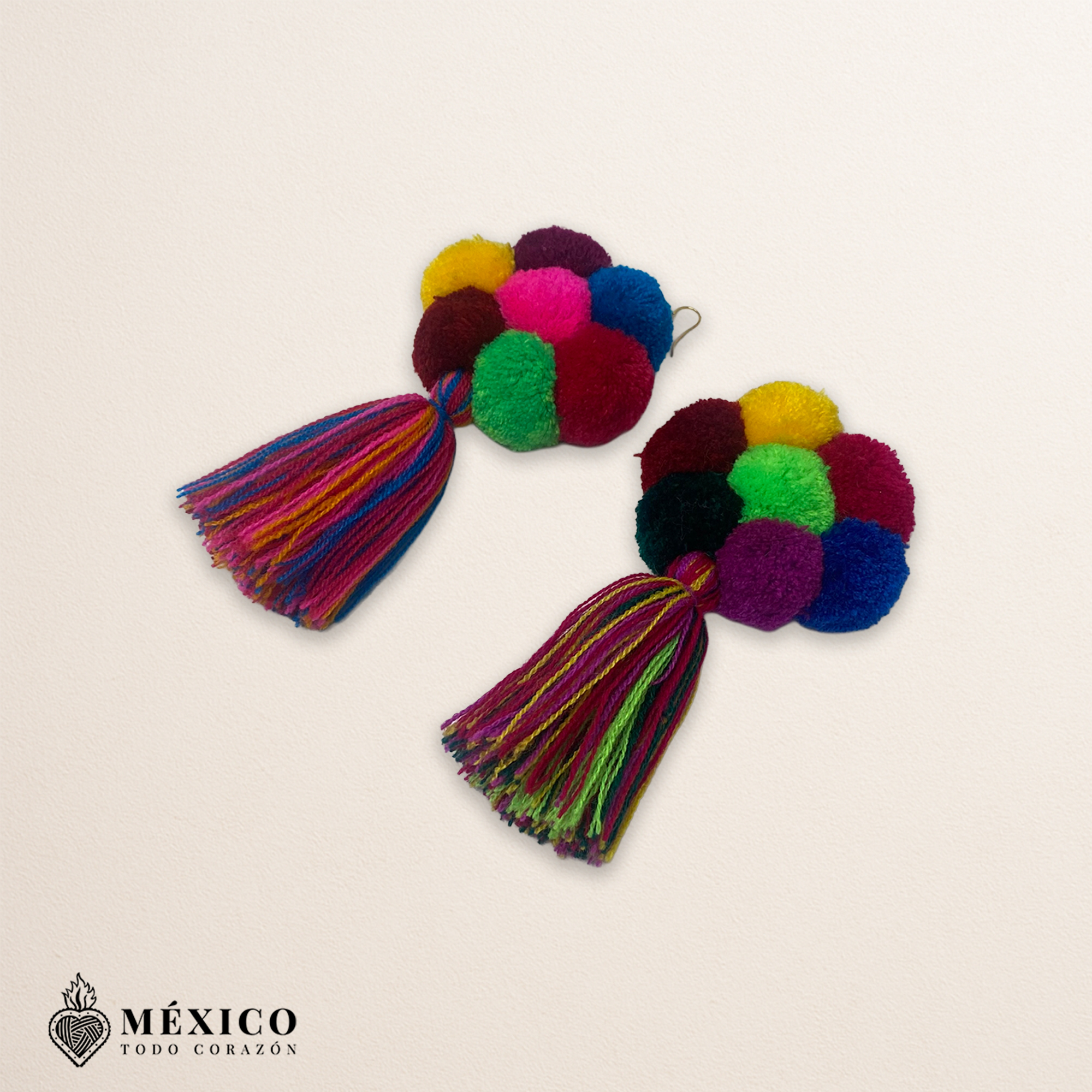 Handmade Mexican flowers earrings featuring multicolor yarn pom-pom embellishments