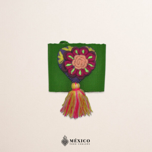 Green artisan Mexican waist belt featuring a floral heart embellishment in multicolor felt