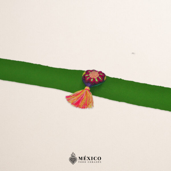 Green artisan Mexican waist belt featuring a floral heart embellishment in multicolor felt