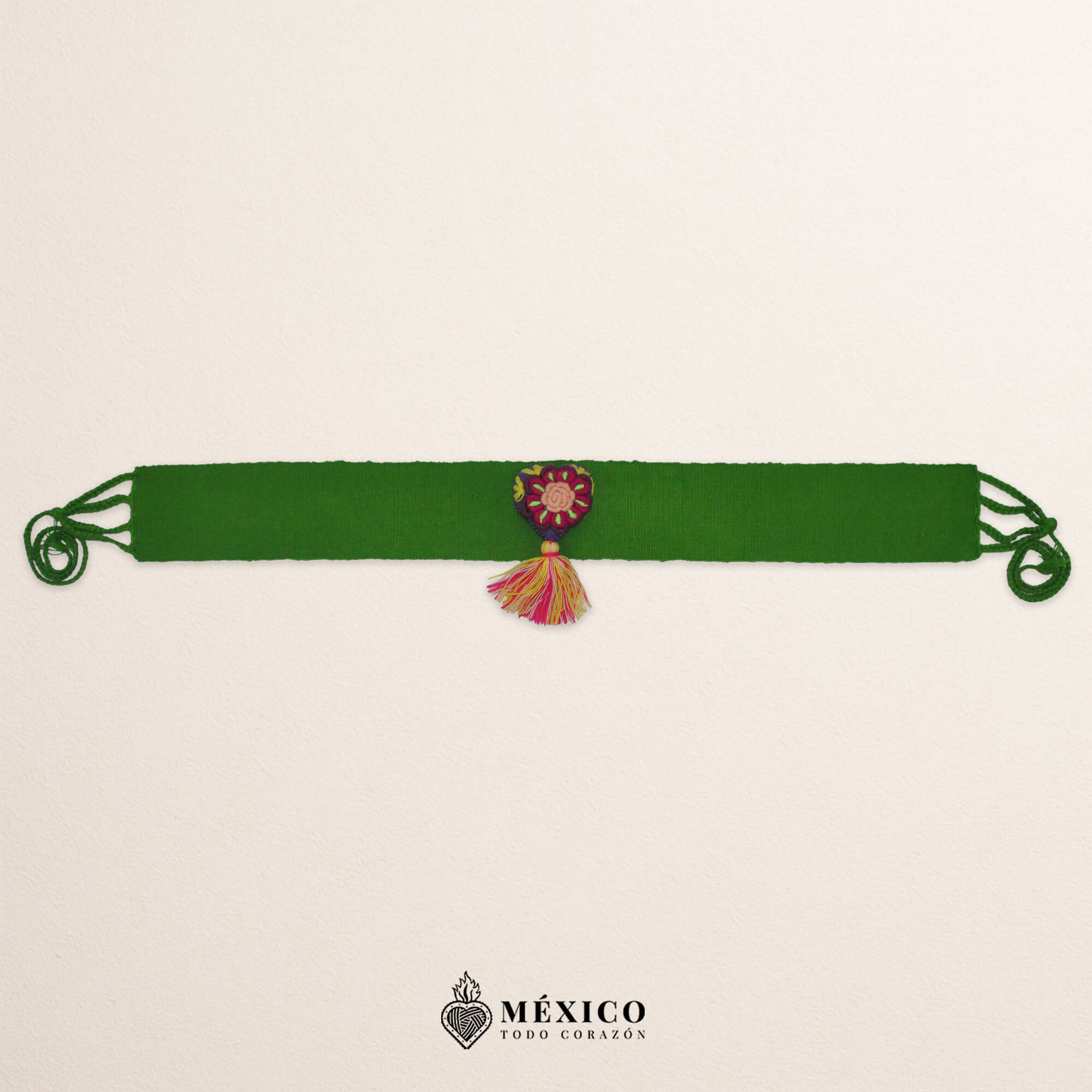 Green artisan Mexican waist belt featuring a floral heart embellishment in multicolor felt