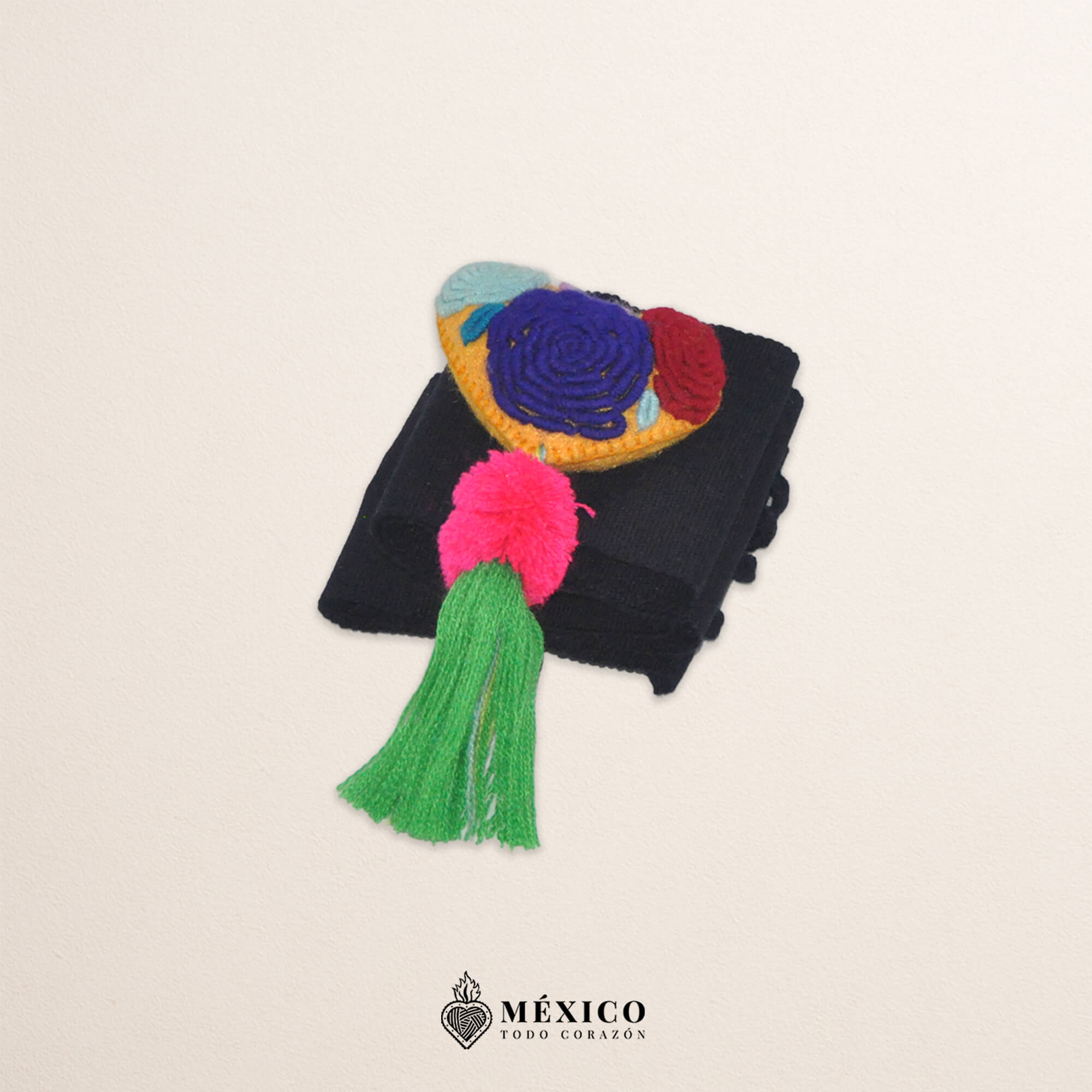 Black artisan waist belt featuring floral embroidery and a heart-shaped felt embellishment