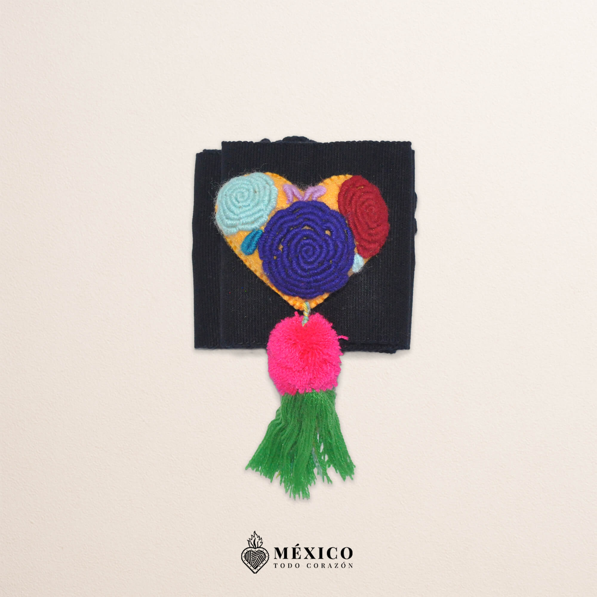 Black artisan waist belt featuring floral embroidery and a heart-shaped felt embellishment