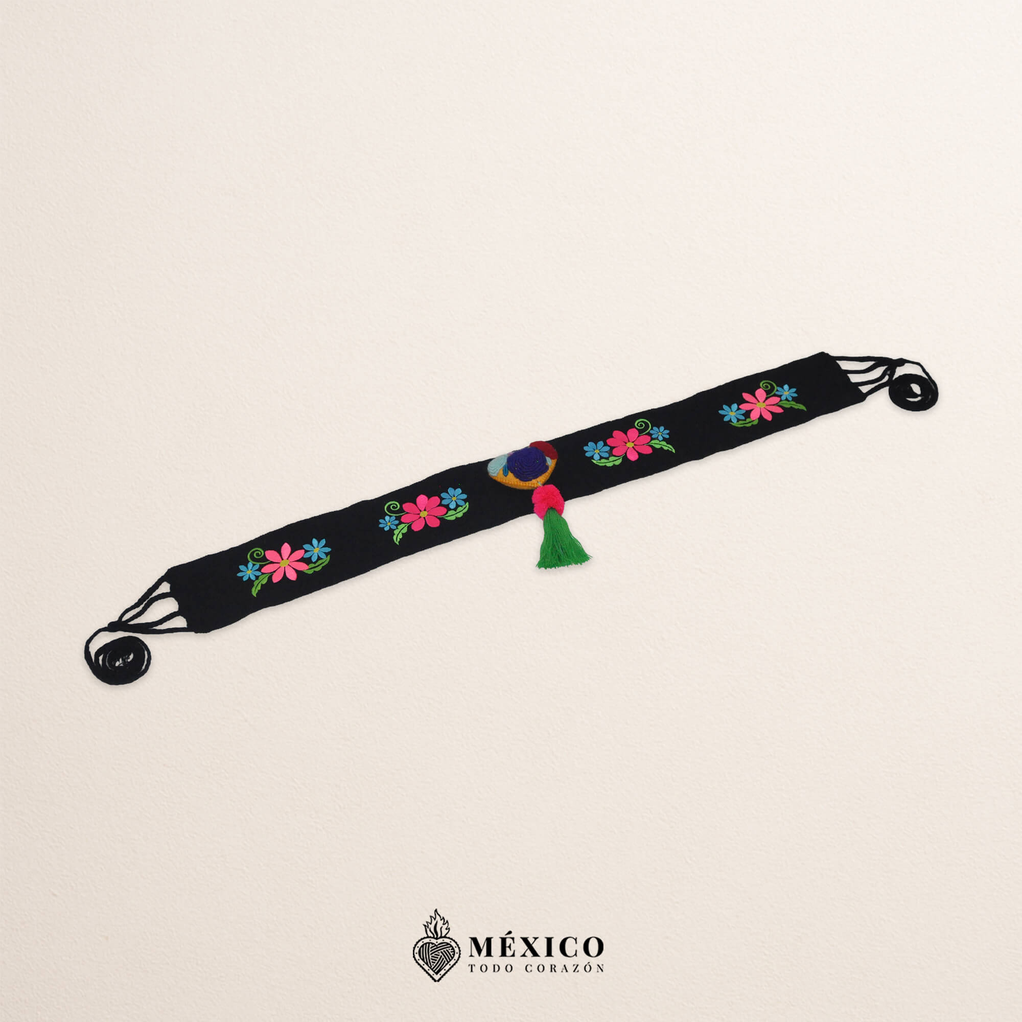 Black artisan waist belt featuring floral embroidery and a heart-shaped felt embellishment