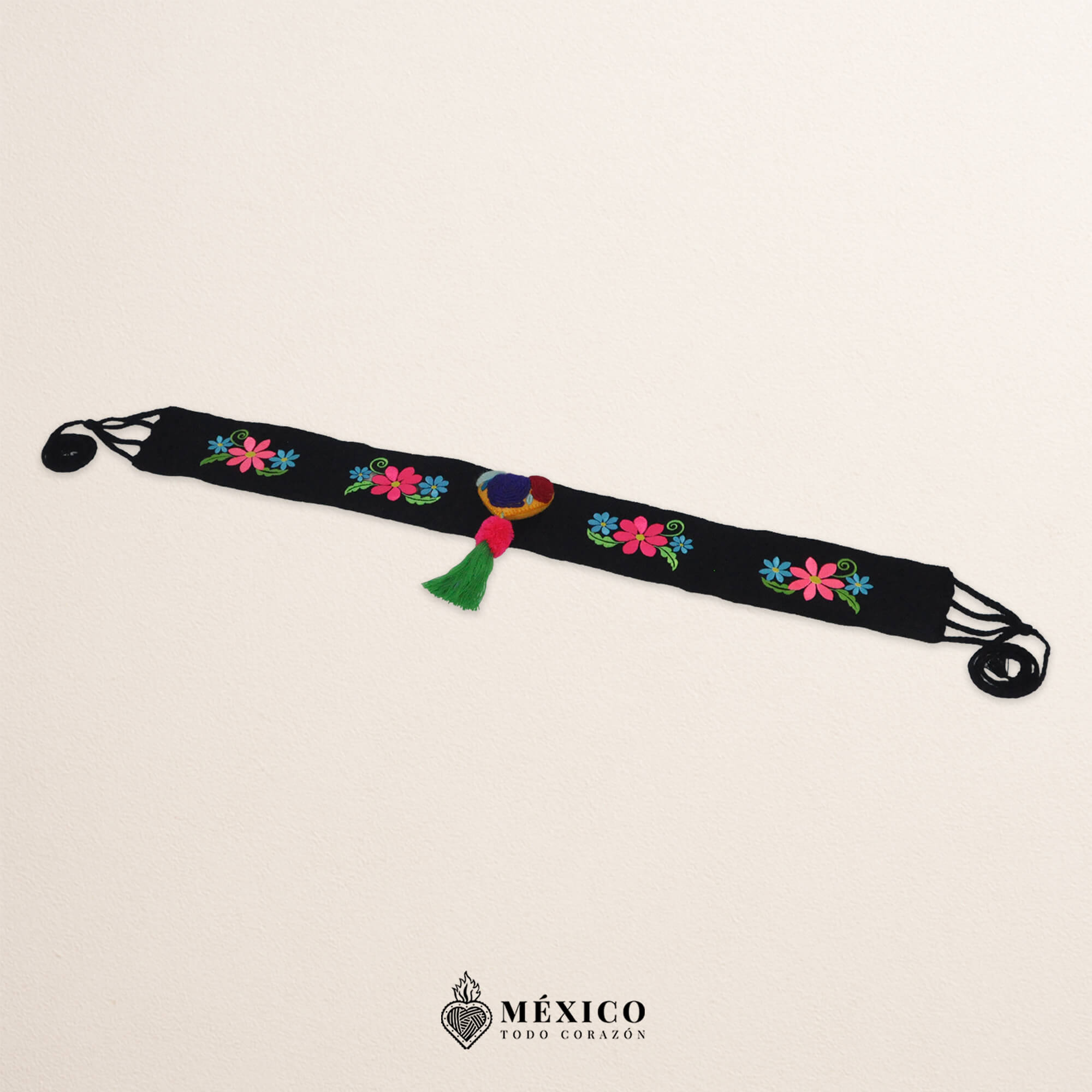 Black artisan waist belt featuring floral embroidery and a heart-shaped felt embellishment