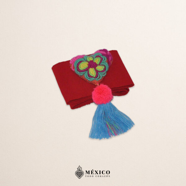 Red artisan waist belt featuring floral embroidery and a heart embellishment in felt appliqué