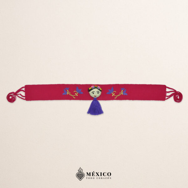 Fuchsia artisan waist belt featuring floral embroidery and a Mexican doll embellishment