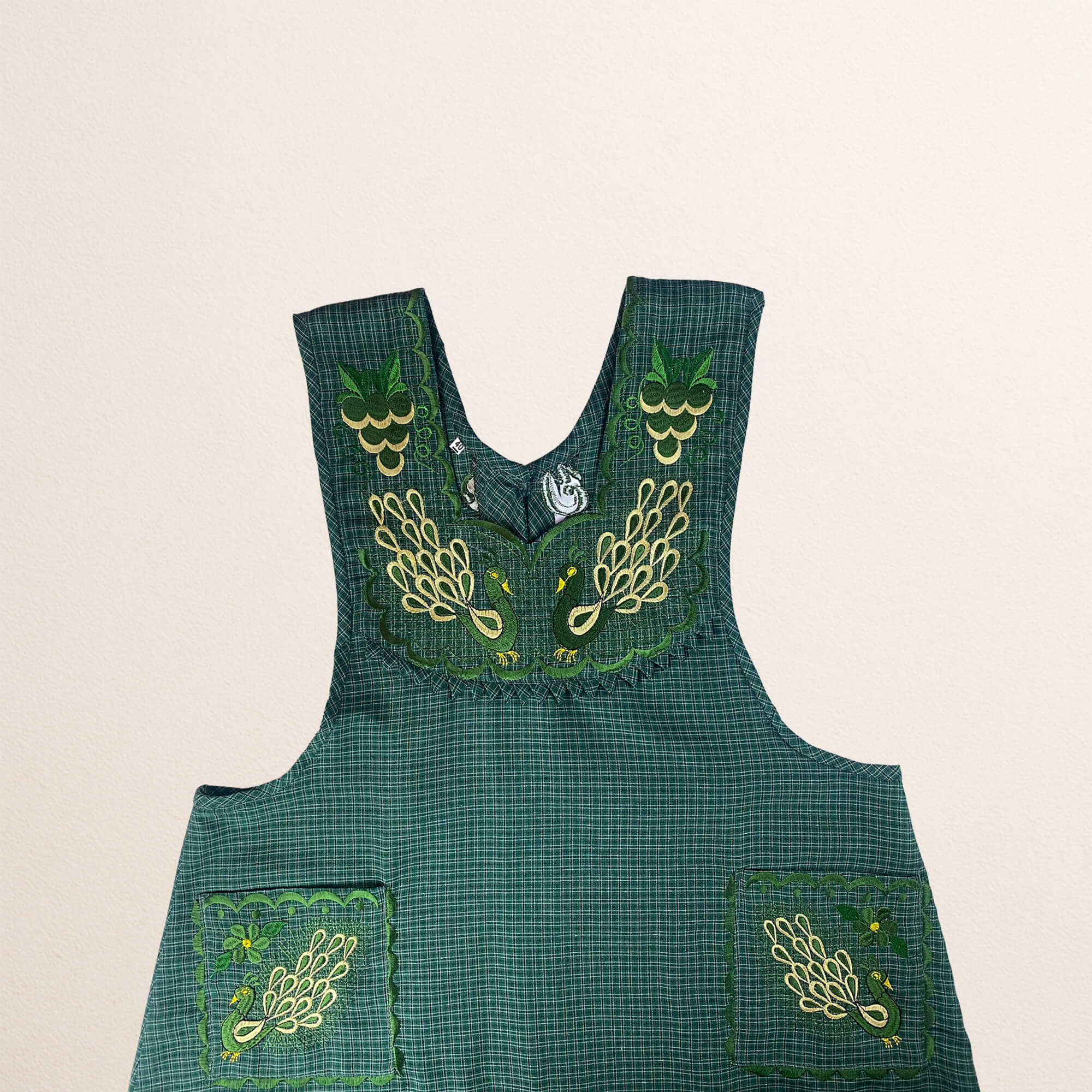 Green Mexican embroidered cotton apron featuring an olive peacock design, perfect kitchen and cooking gift
