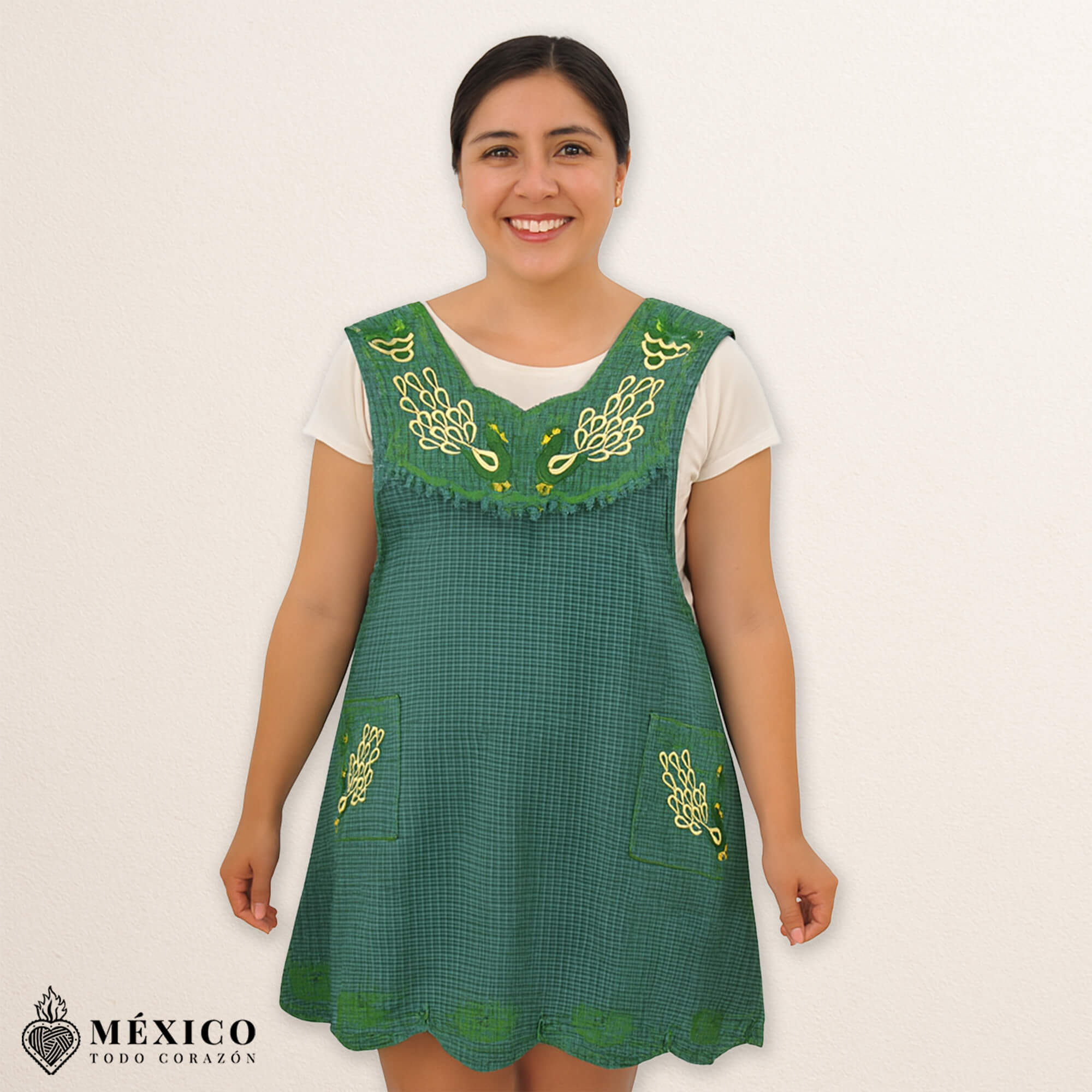 Green Mexican embroidered cotton apron featuring an olive peacock design, perfect kitchen and cooking gift