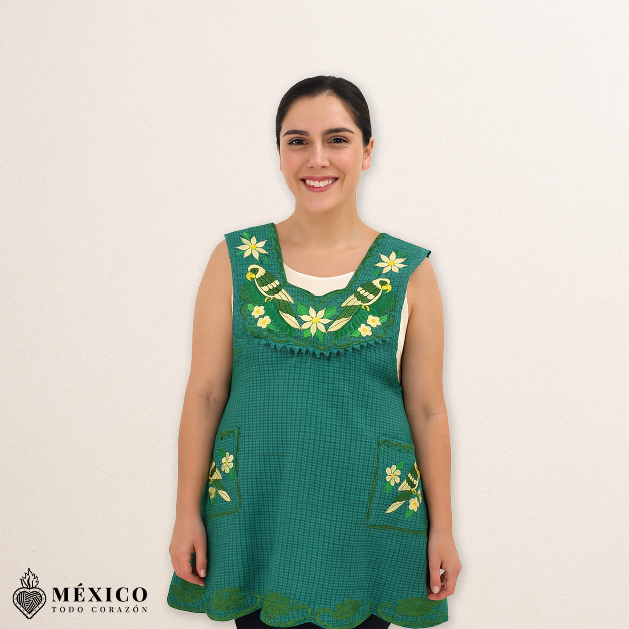 Green Mexican embroidered cotton apron featuring floral and bird motifs, perfect kitchen and cooking gift