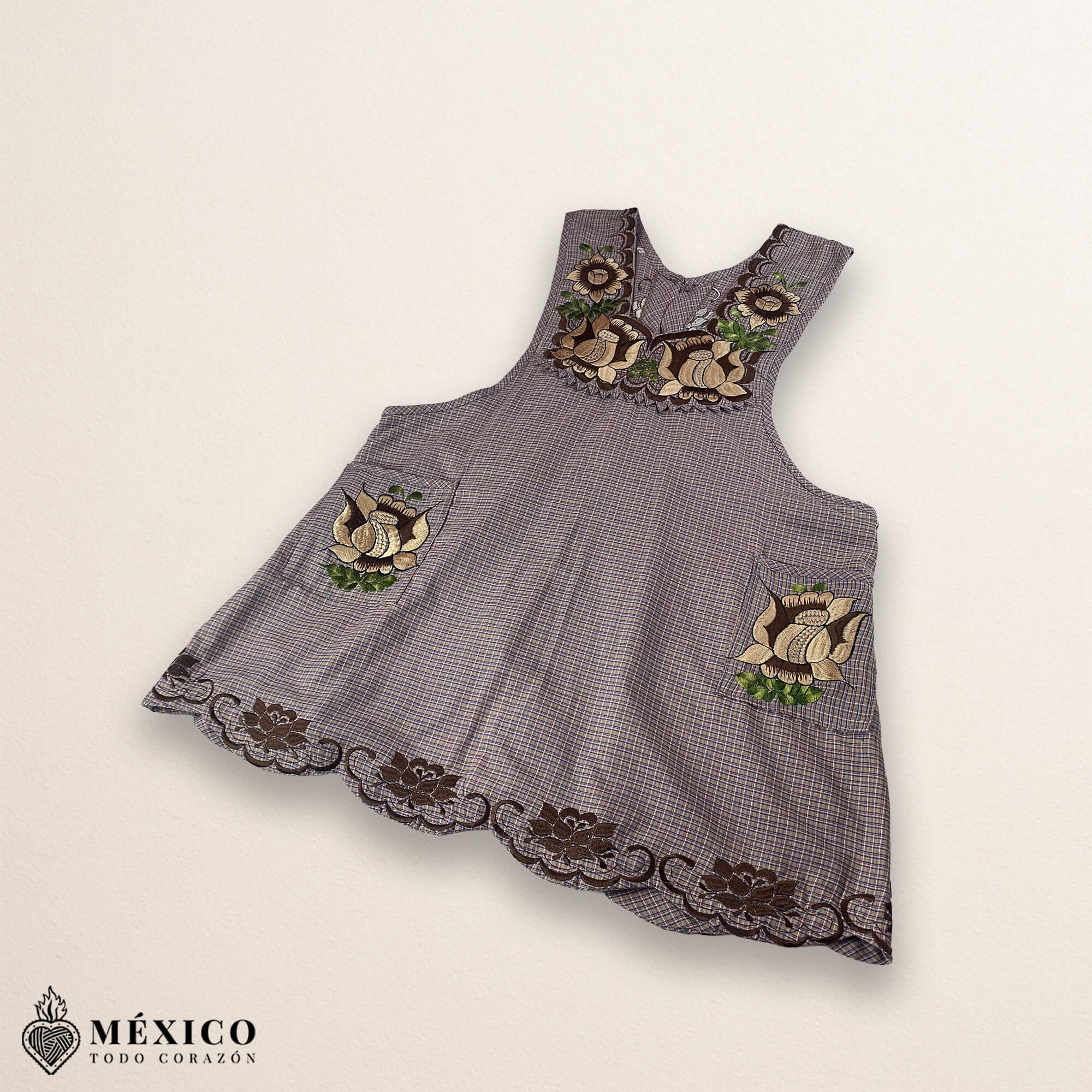 Light brown Mexican embroidered cotton apron featuring beige floral patterns, ideal kitchen and cooking gift.