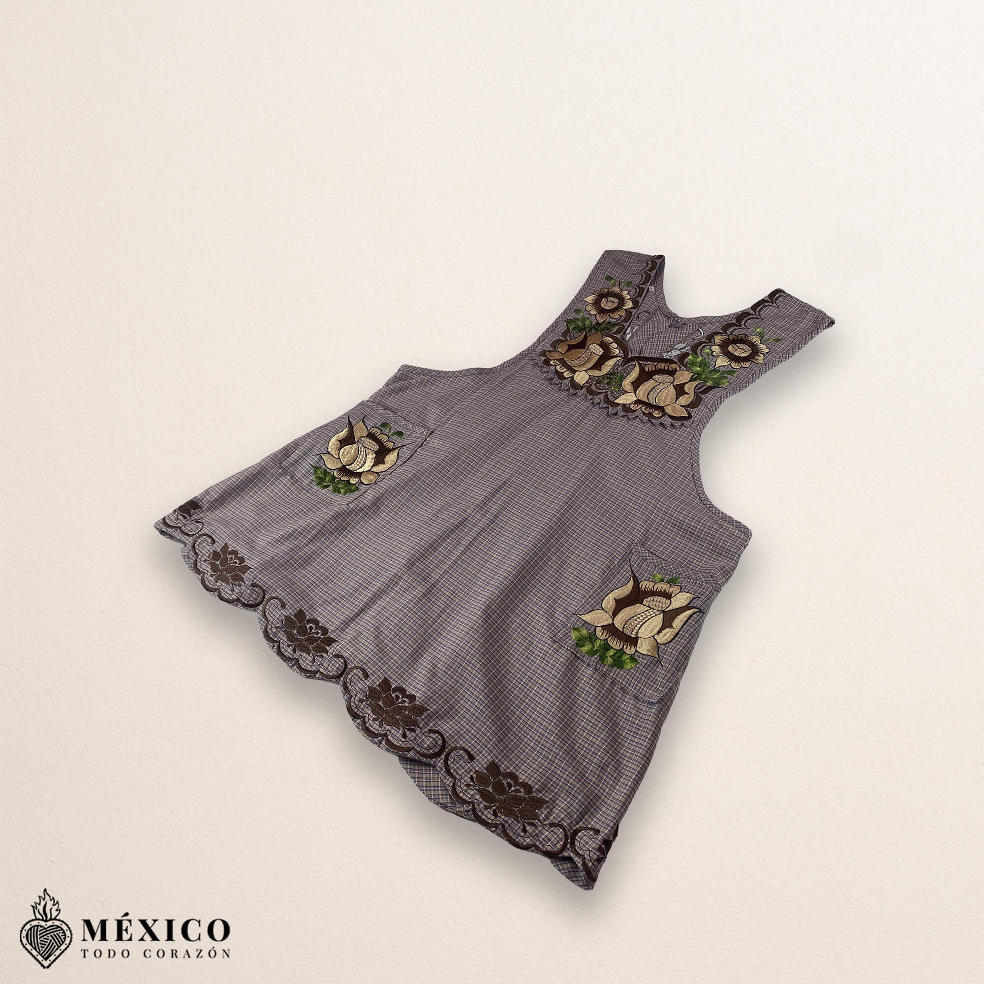 Light brown Mexican embroidered cotton apron featuring beige floral patterns, ideal kitchen and cooking gift.