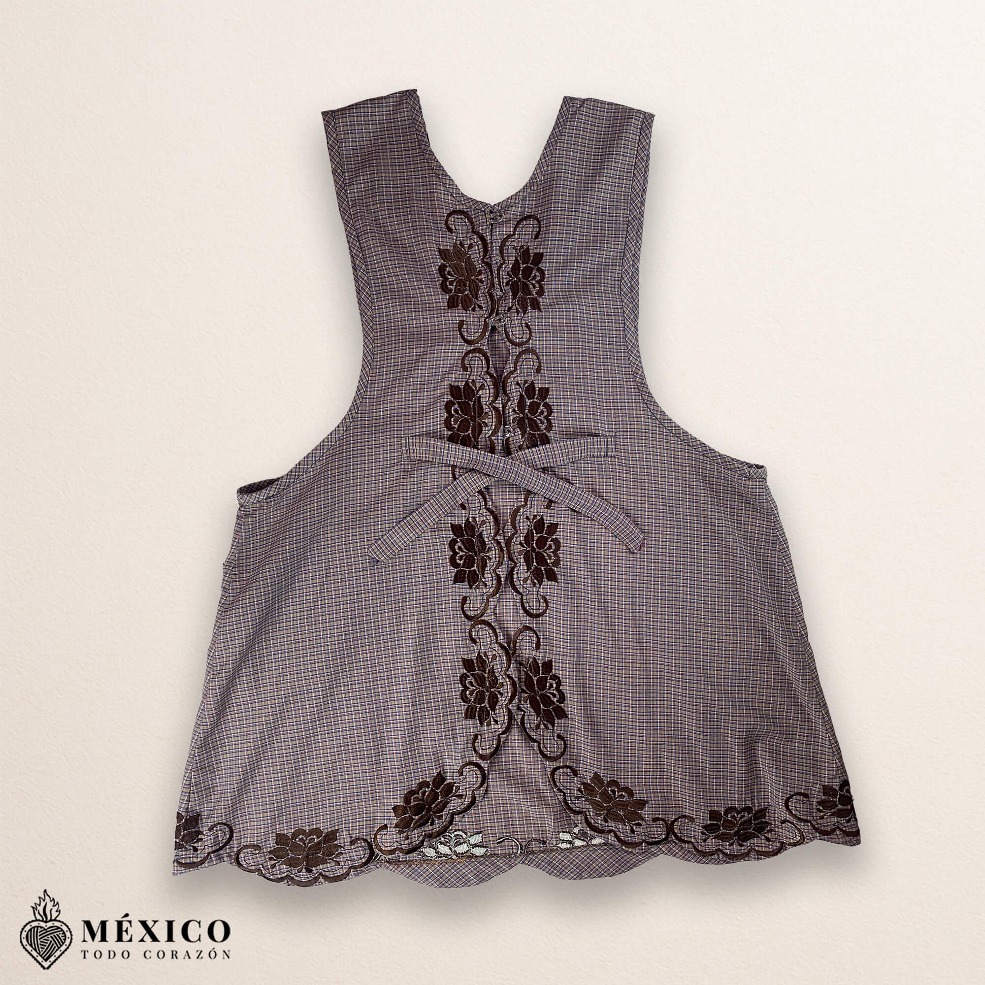 Light brown Mexican embroidered cotton apron featuring beige floral patterns, ideal kitchen and cooking gift.