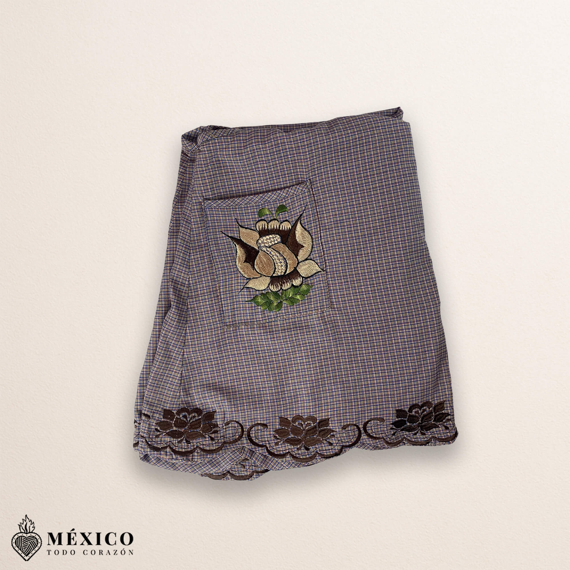 Light brown Mexican embroidered cotton apron featuring beige floral patterns, ideal kitchen and cooking gift.