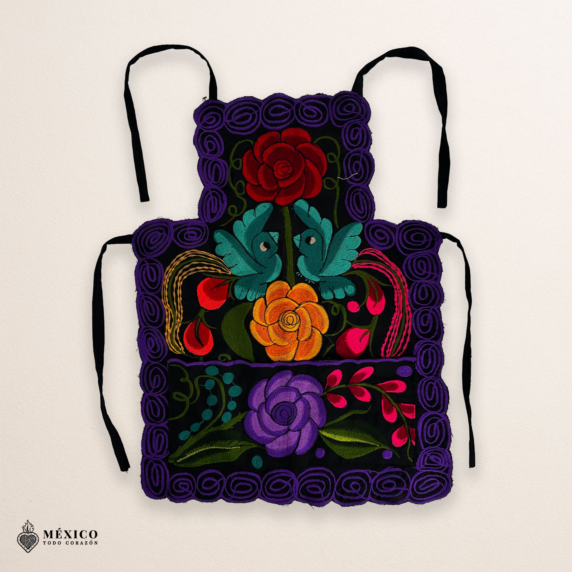 Mexican embroidered bib apron for women in multicolor cotton fabric, featuring vibrant floral design — handmade traditional kitchen apron perfect for cooking, gifts, and cultural celebrations.