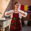 Mexican embroidered bib apron for women in multicolor cotton fabric, featuring vibrant floral design — handmade traditional kitchen apron perfect for cooking, gifts, and cultural celebrations.
